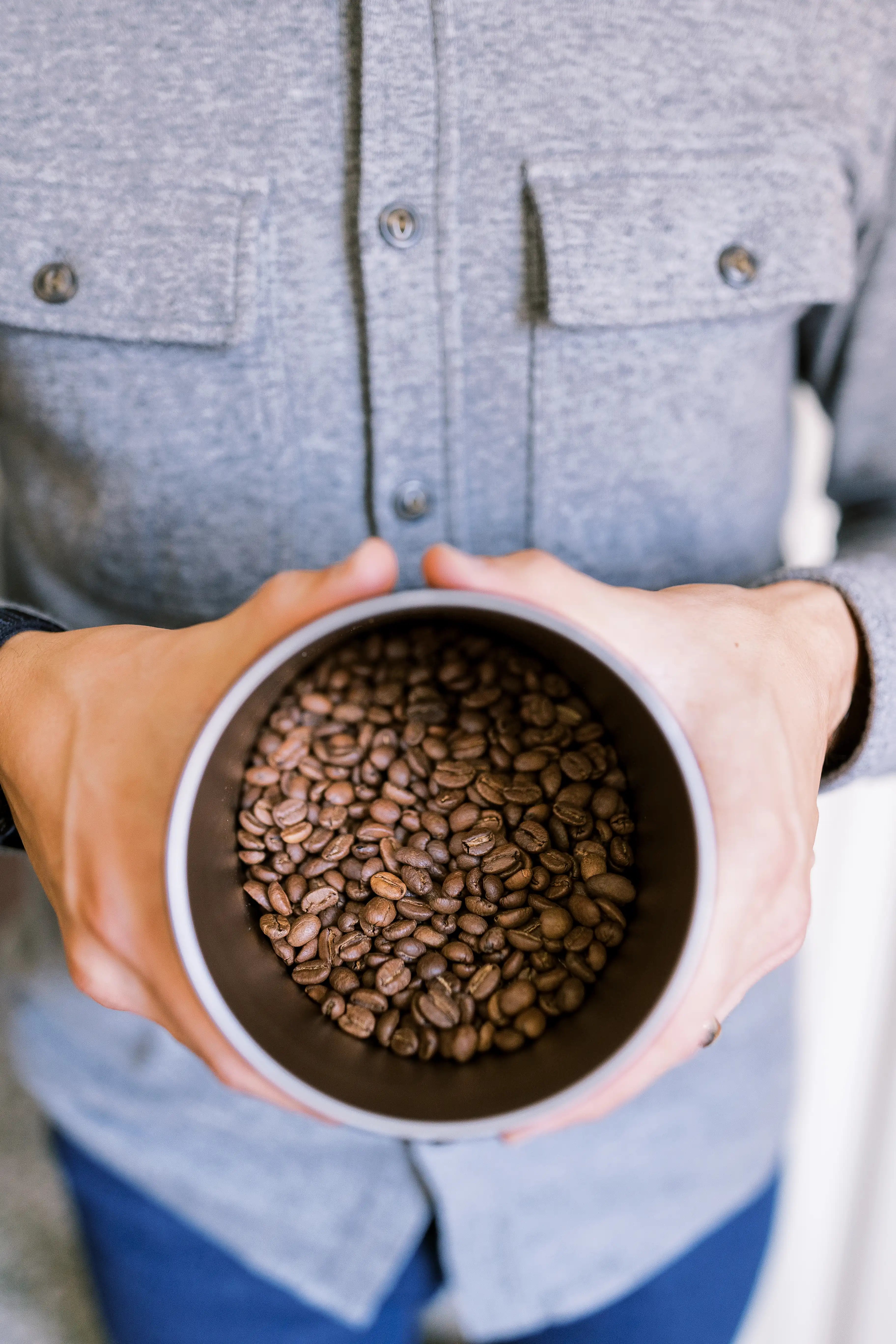 Hands holding coffee beans